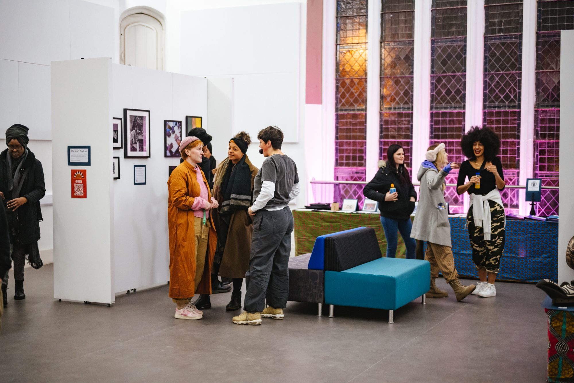 groups of people chatting in an art gallery spsace