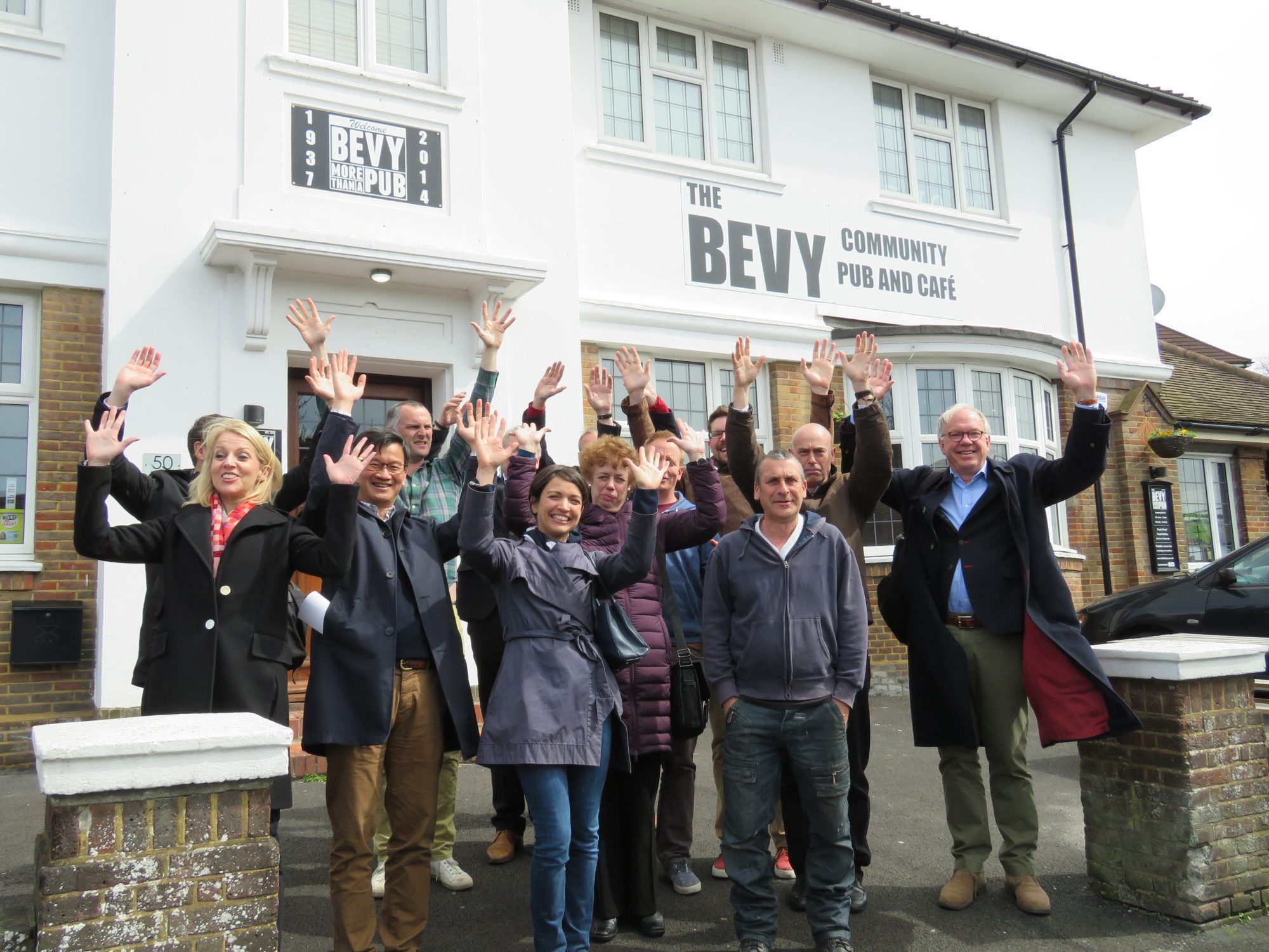 The Bevendean Community Pub (The Bevy)_people outside The Bevy with arms raised