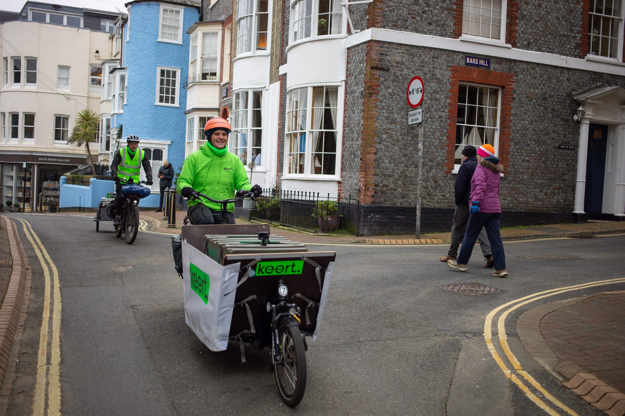 People cycling in high vis through a street
