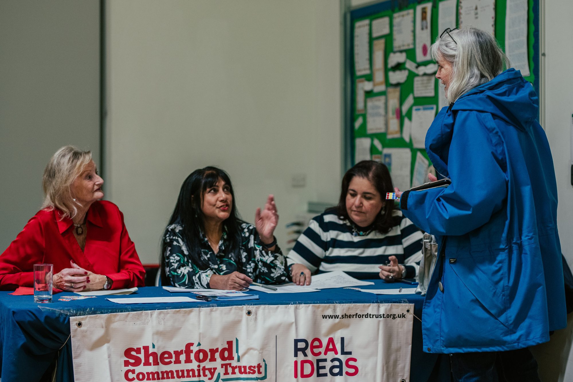 People chatting at a Sherford Community Landtrust stall chat