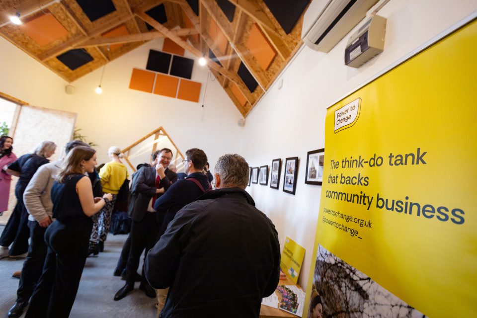 People at an event with a power to change banner