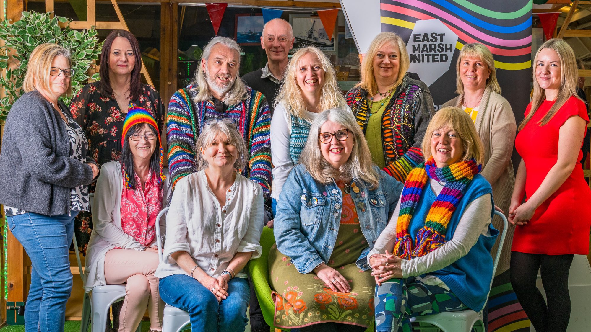 Twelve members of East Marsh United in a group photo standing and sitting